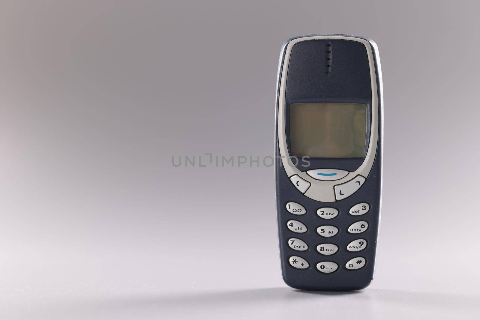 Georgia Tbilisi June 23, 2022: Original Nokia 3310 on gray background by kuprevich