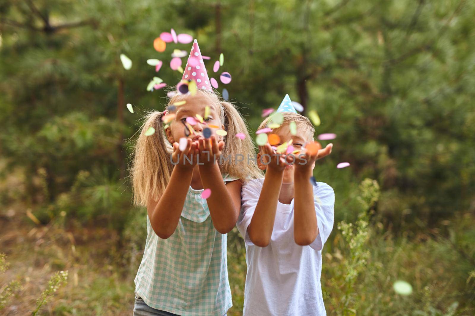 happy birthday children with confetti on outdoor bithday party by InnaVlasova