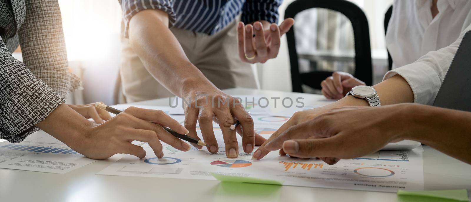 Businesspeople analyzing investment graph meeting brainstorming and discussing plan in meeting room, investment concep