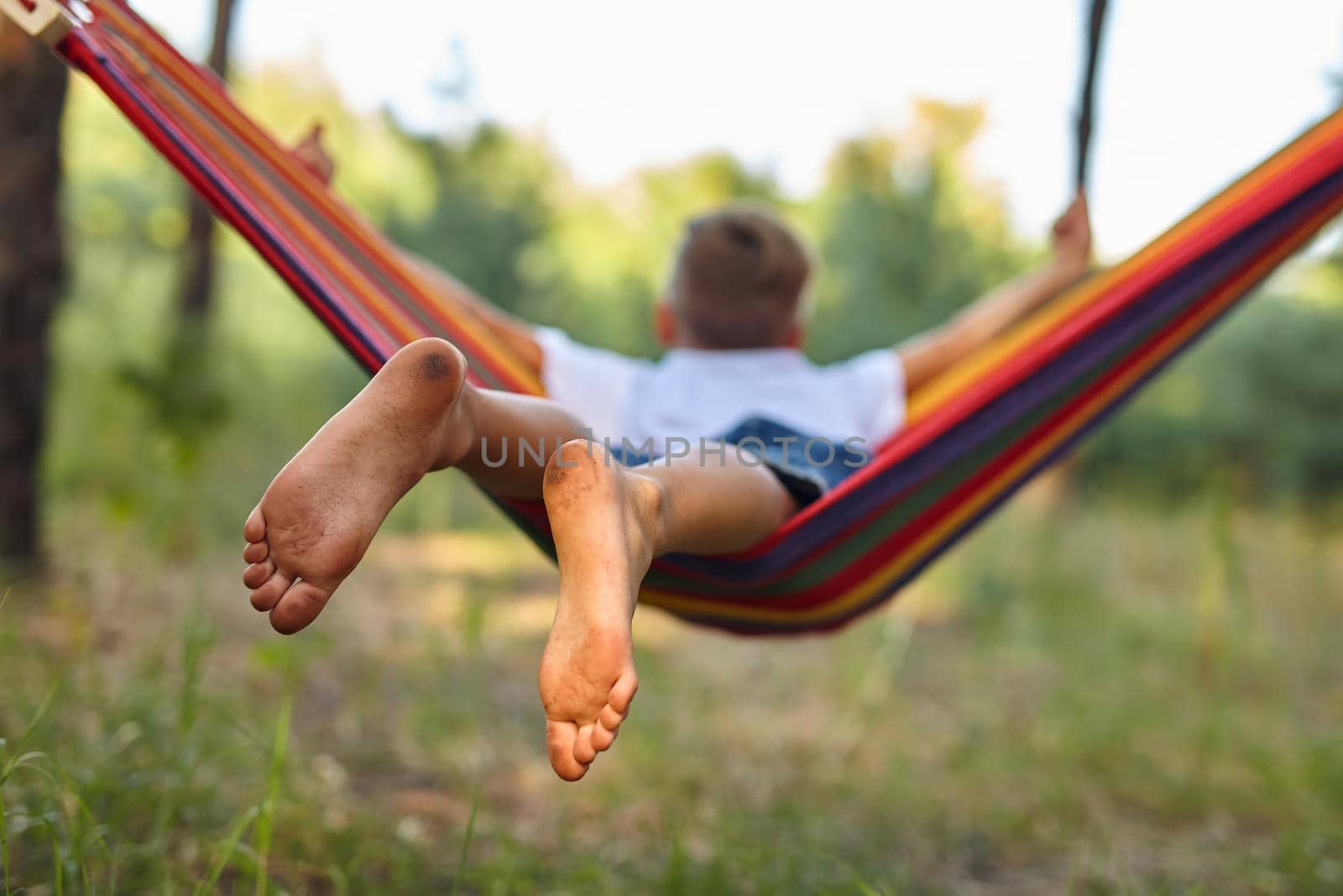 Cute boy is sitting in a hammock. by InnaVlasova