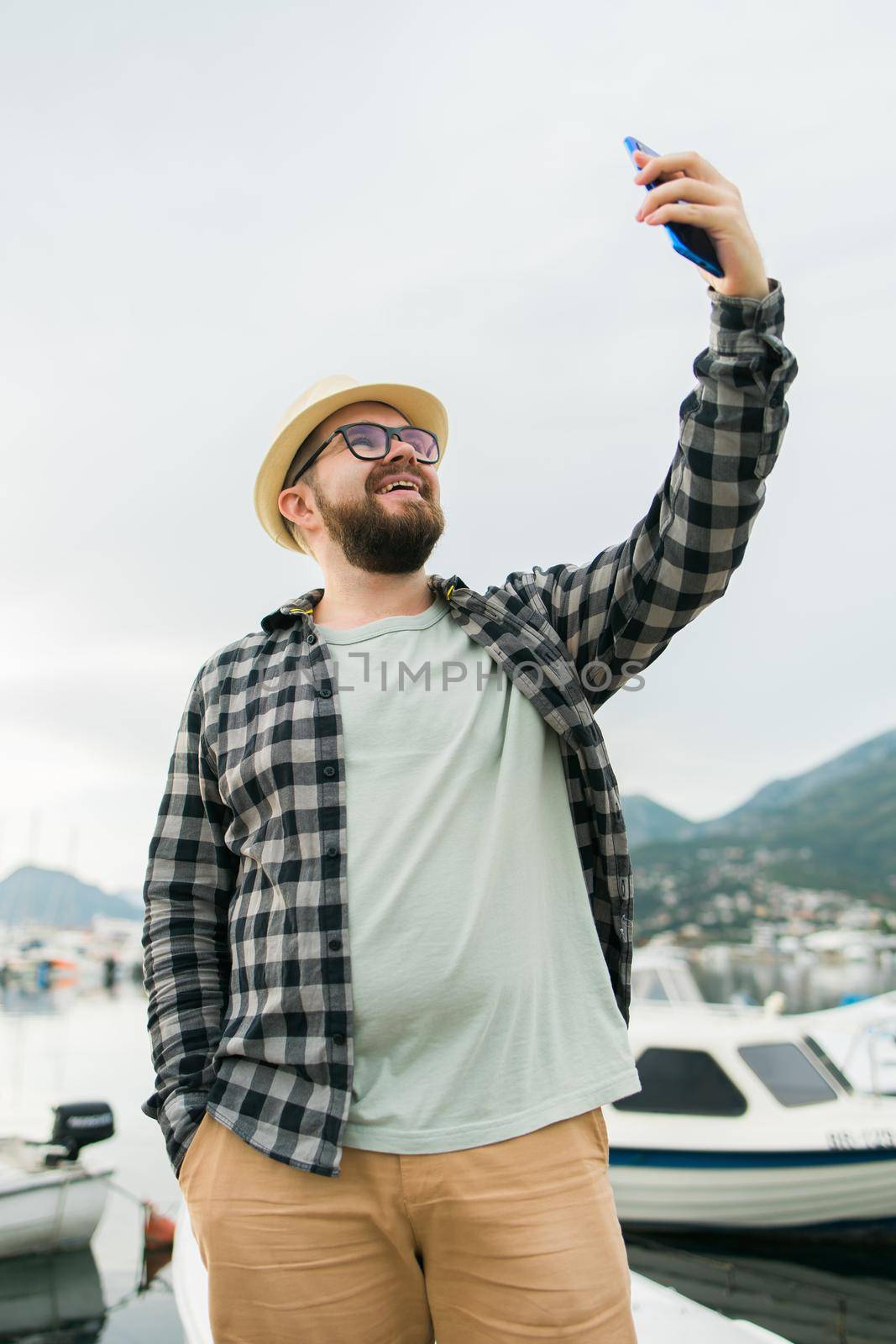Traveller man taking selfie of luxury yachts marine during sunny day - travel and summer concept by Satura86