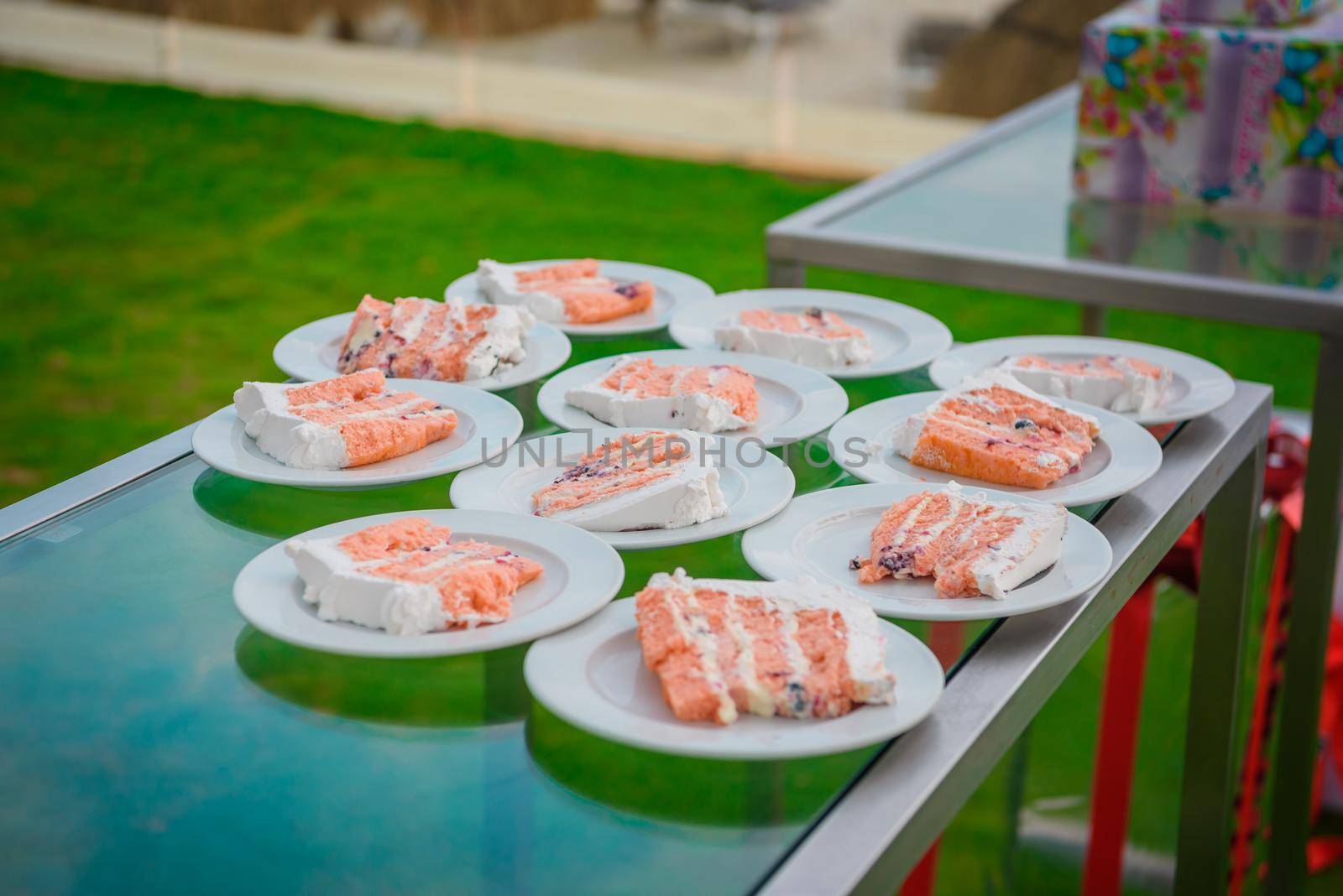 White and pink cake neatly laid out on plates.