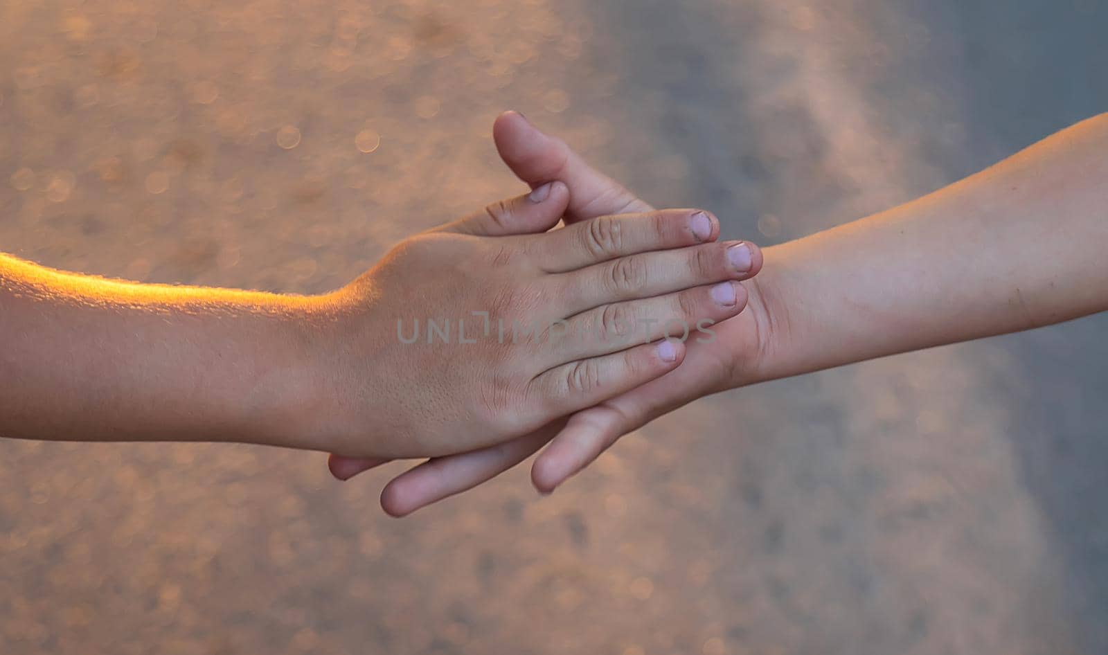 Children walk hand in hand. Selective focus. Kids,