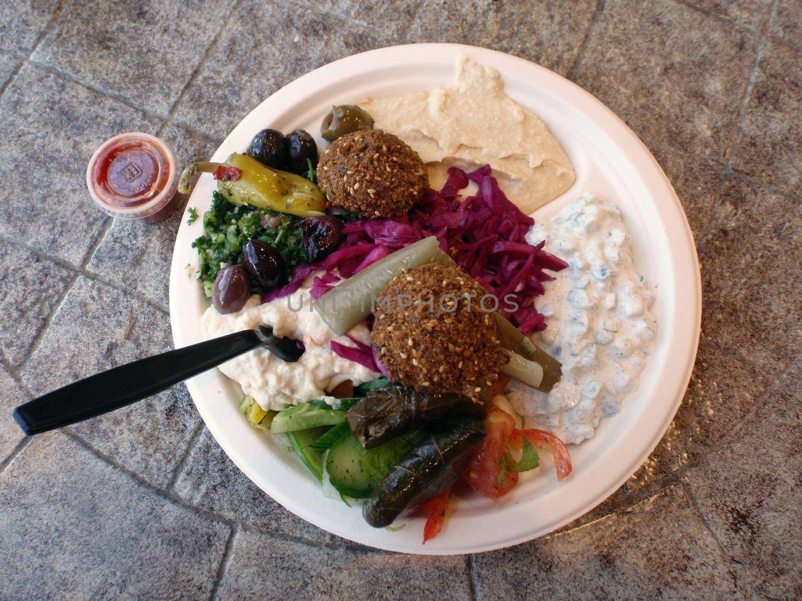 Mezza Veggie Plate: A beautiful selection of fresh Tabouli salad, Babaganoush,                                                                   Greek salad, Cucumber with yogurt and Humus, Fresh falafel with homemade tahini sauce, Pita and lavash bread, Variety of pickles, olives, and hot sauce.  