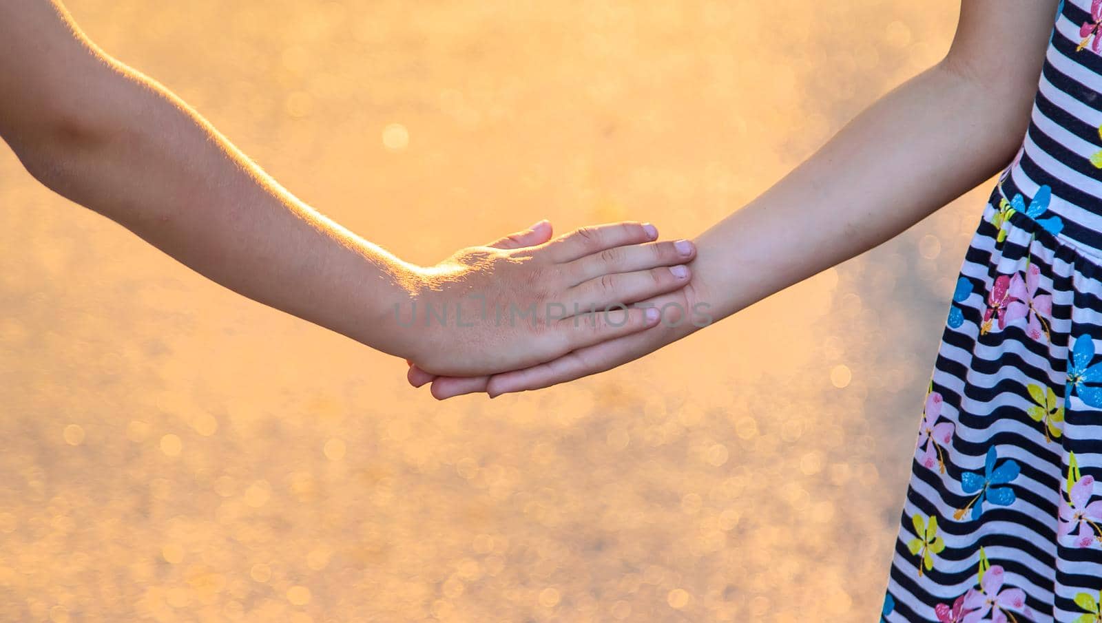 Children walk hand in hand. Selective focus. Kids,