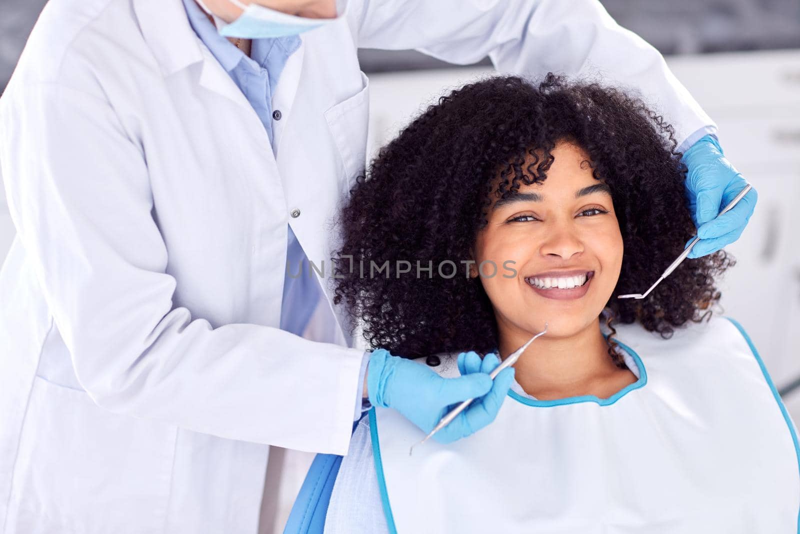Shot of a young female patient having her teeth examined at the dentist.