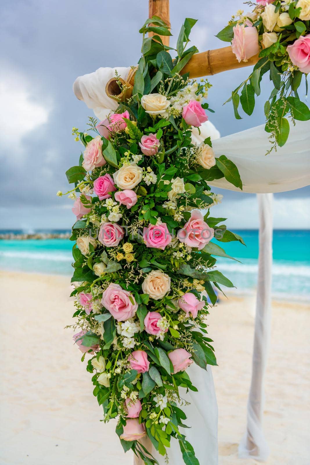 Scenery of flowers of white roses on a wedding arch.