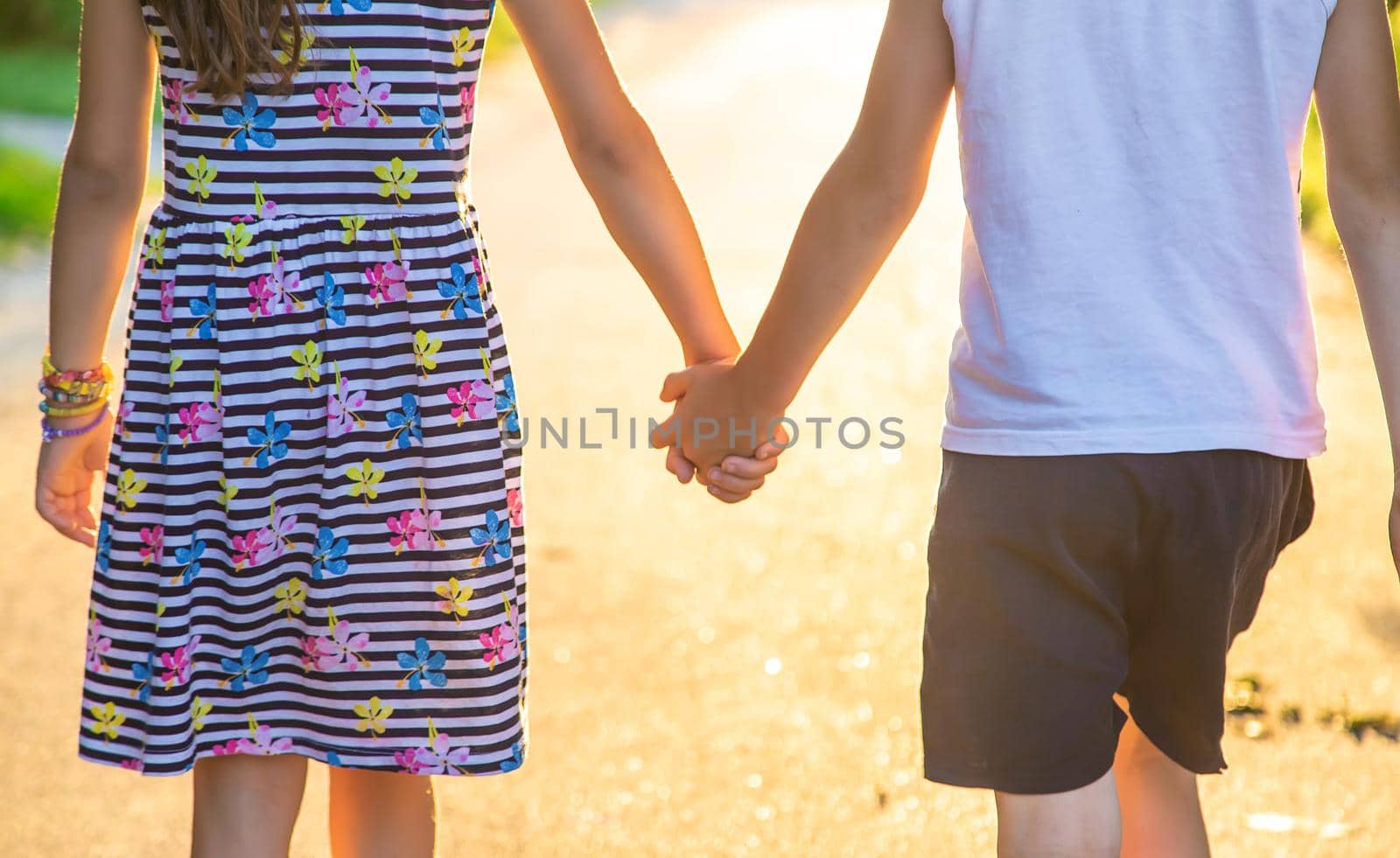 Children walk hand in hand. Selective focus. Kids,