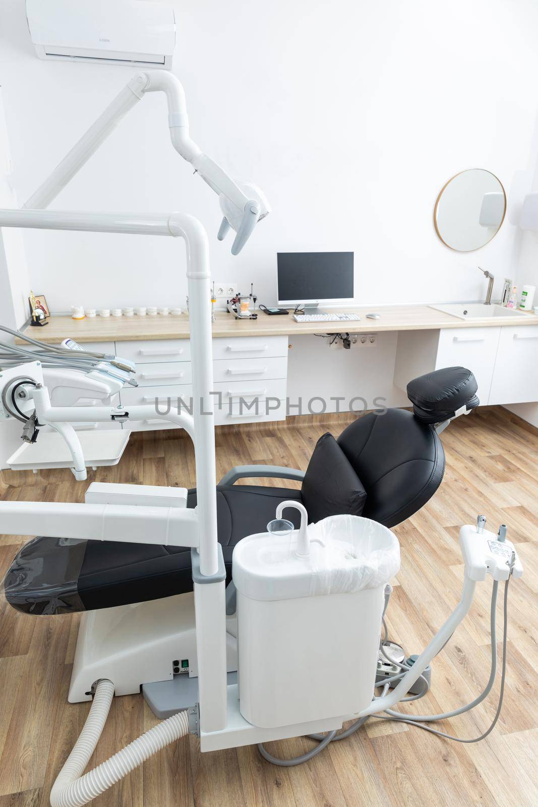 Modern dental cabinet in white colors. Defferent dental equipment, chair, lamp, drill machines. Concept dental treatment by Mariakray