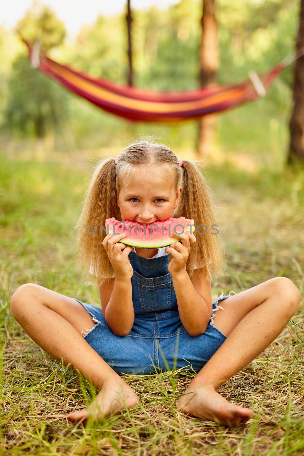 Funny girl eating watermelon in the park. by InnaVlasova