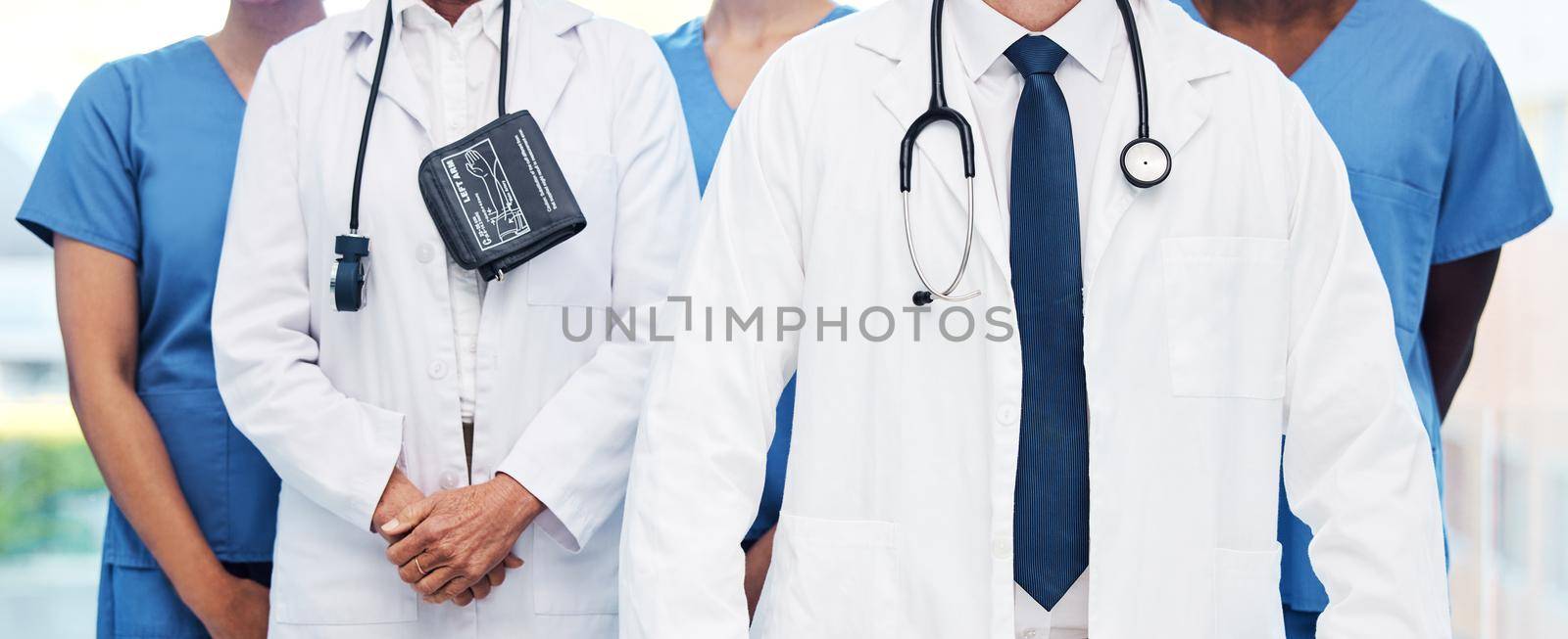 Were ready for work. Shot of a group of unrecognizable doctor standing at a clinic. by YuriArcurs
