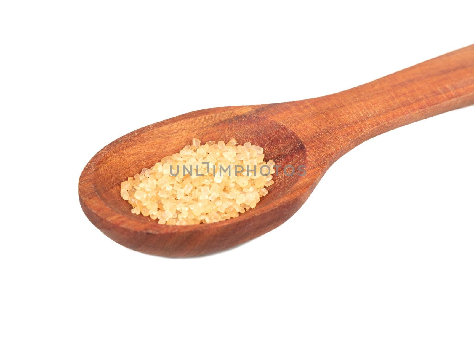 Wooden spoon with brown sugar on a white background