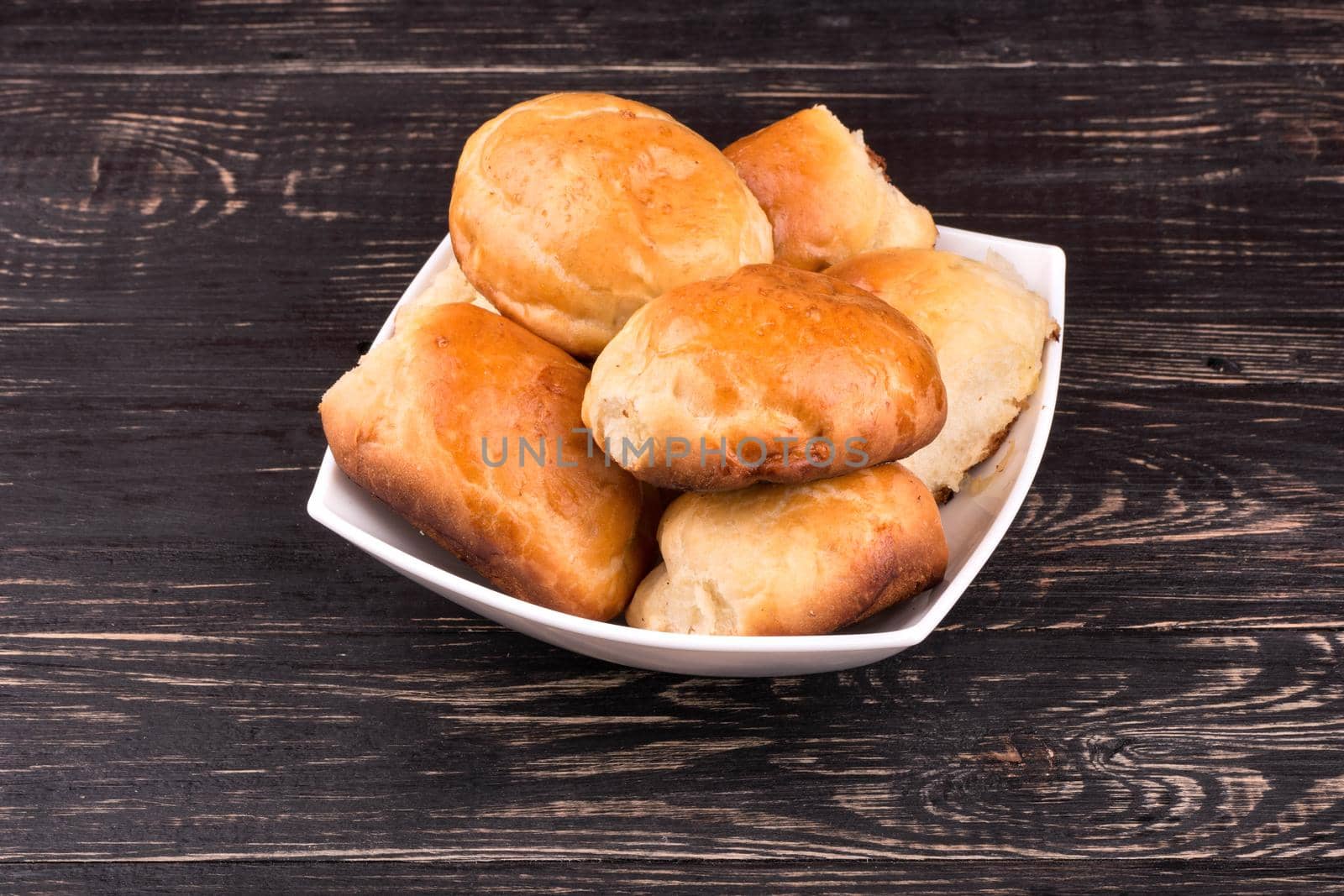 Full bowl of homemade pie on a wooden background