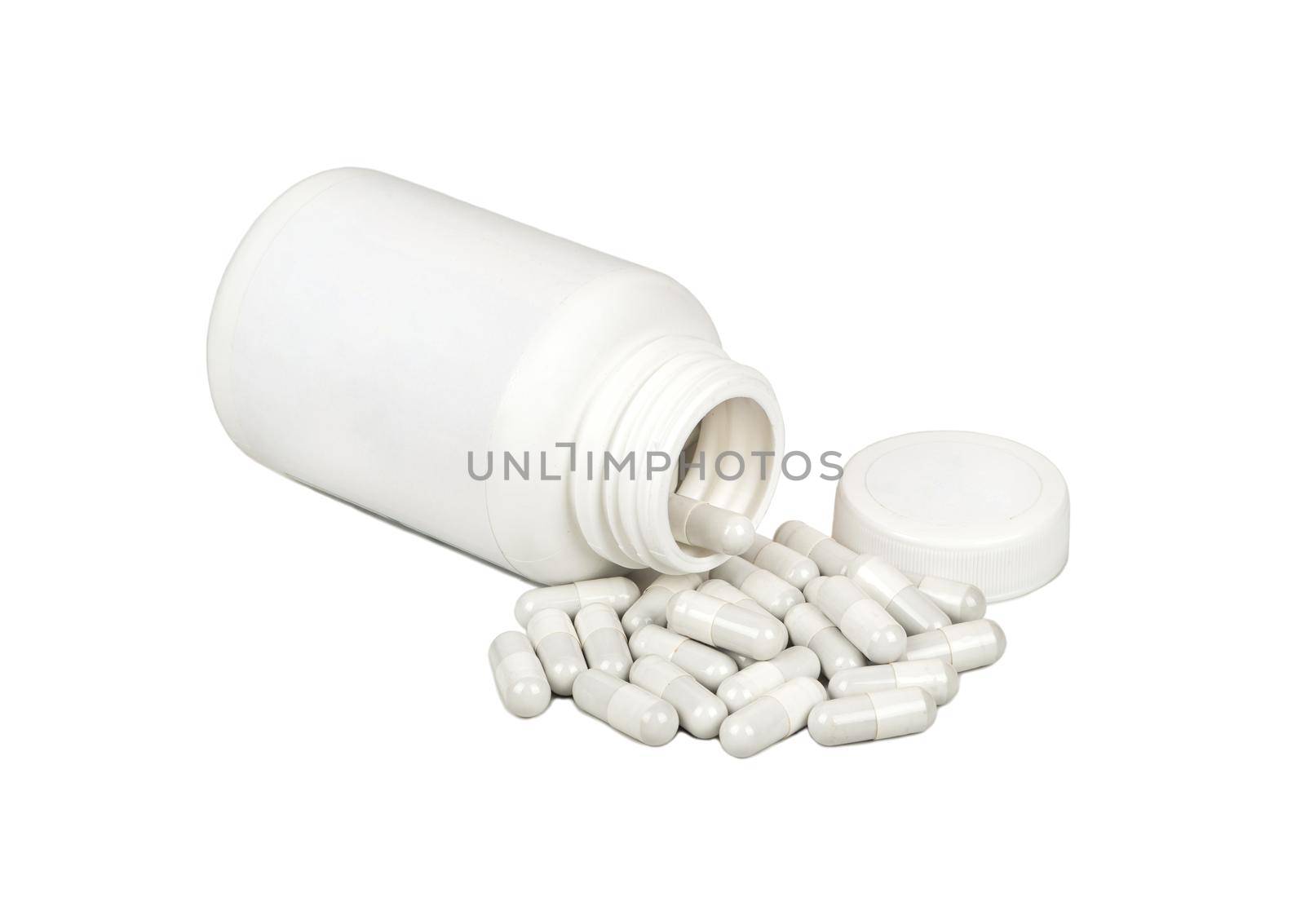 Scattered capsules with a plastic jar on a white background