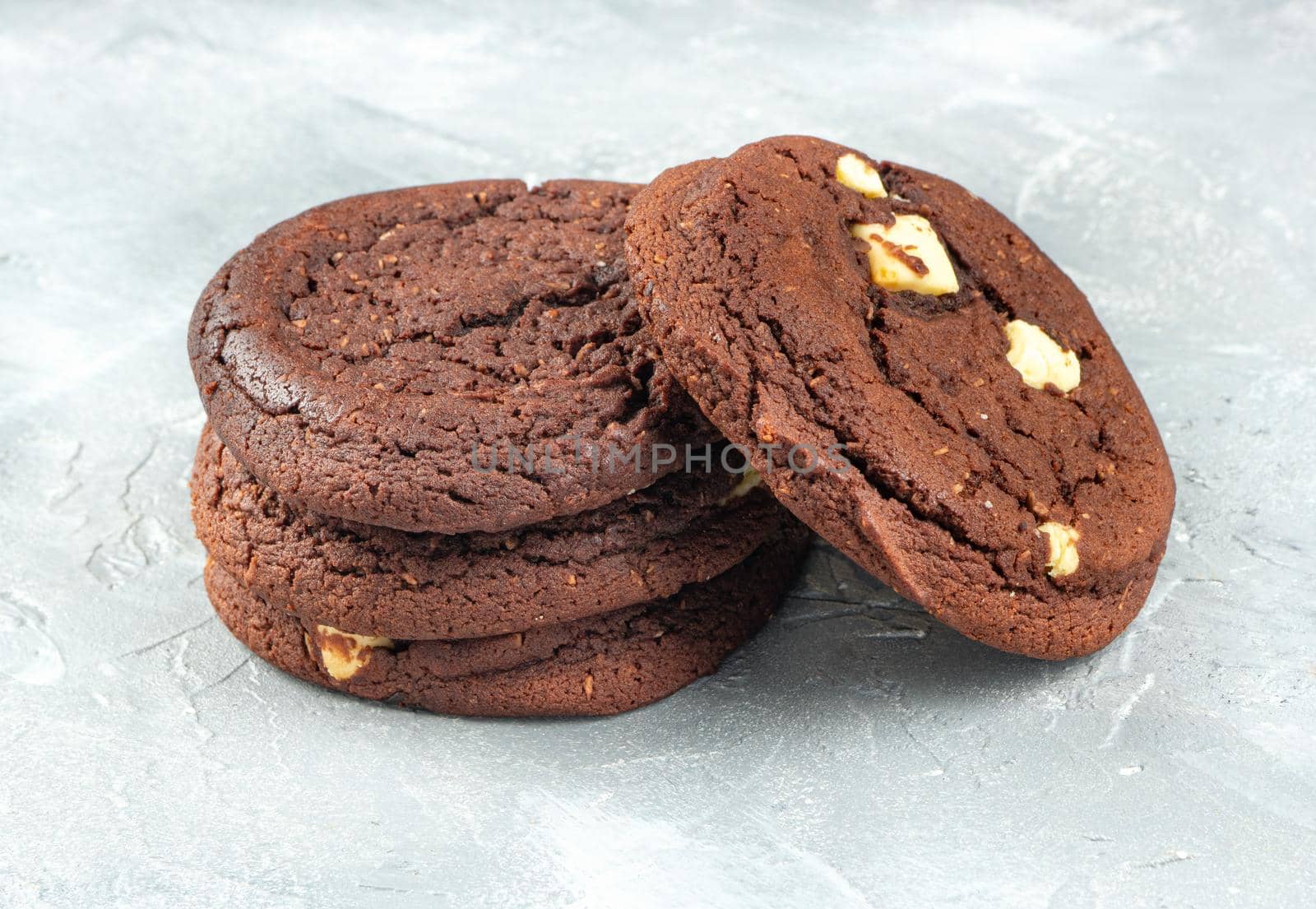 Homemade chocolate cookies with coconut on a concrete background