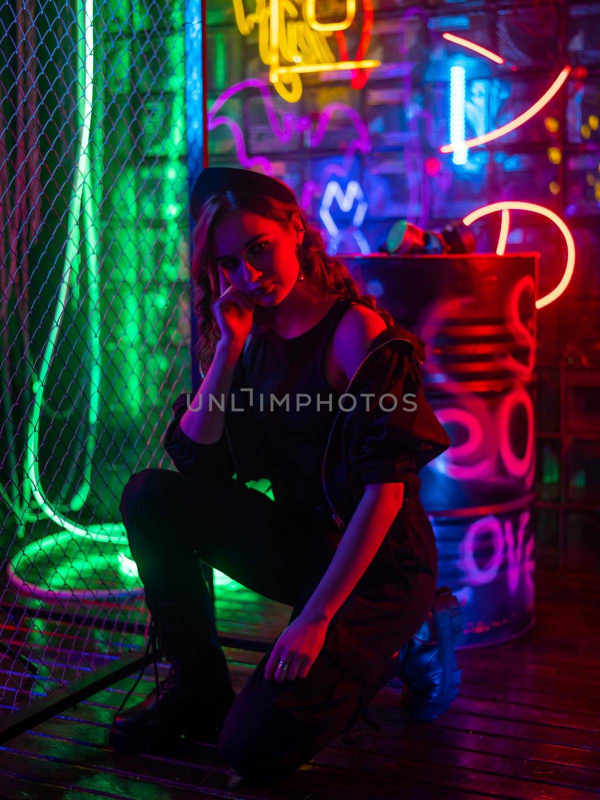 Caucasian woman posing in neon studio. by mrwed54