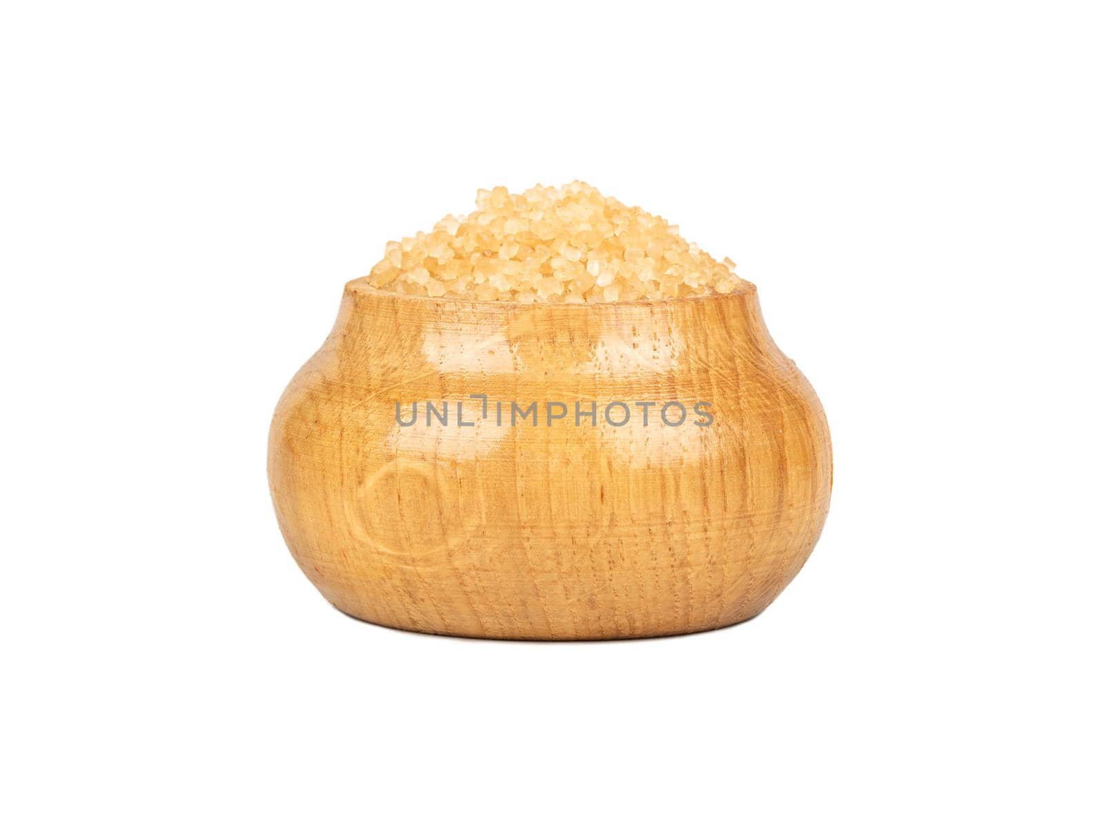 Brown sugar in a wooden container isolated on a white background