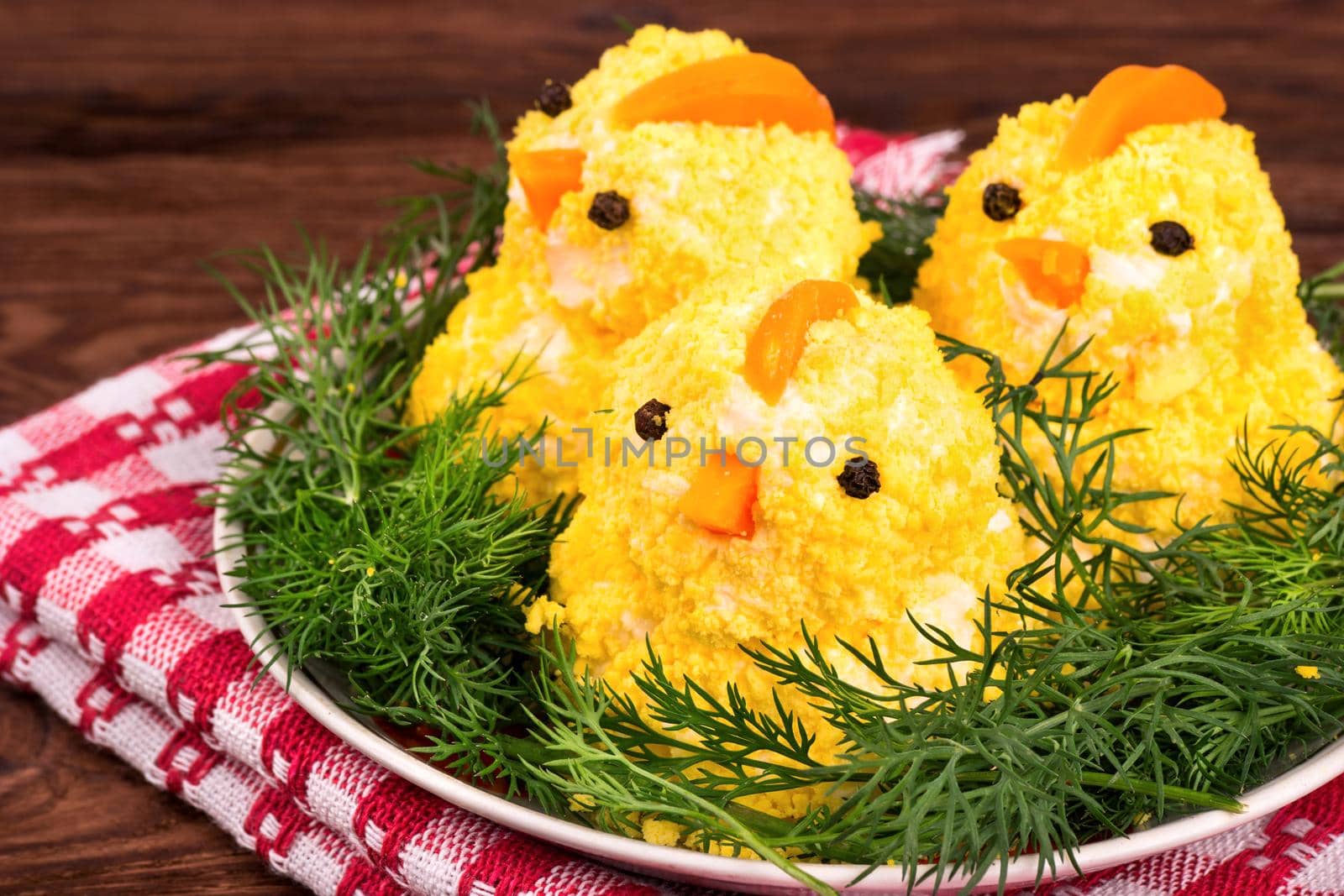 A dish of chicken eggs on a platter with dill on a towel and table closeup