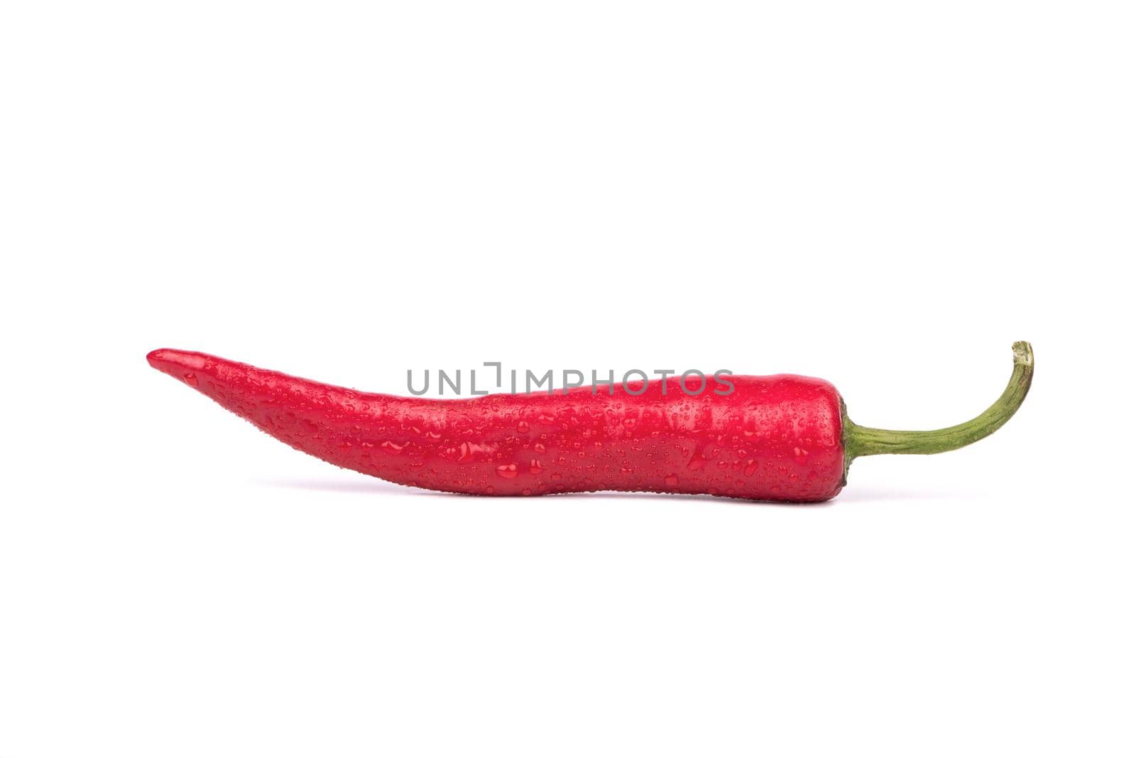 Fresh red hot chili pepper with drops on white background