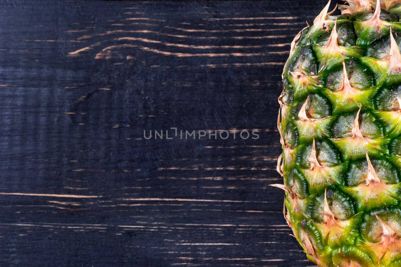 Fresh tropical fruit pineapple on wooden background empty closeup