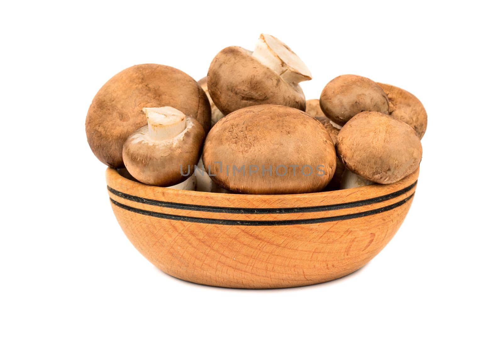 Wooden bowl filled with fresh royal mushrooms champignons isolated on white background