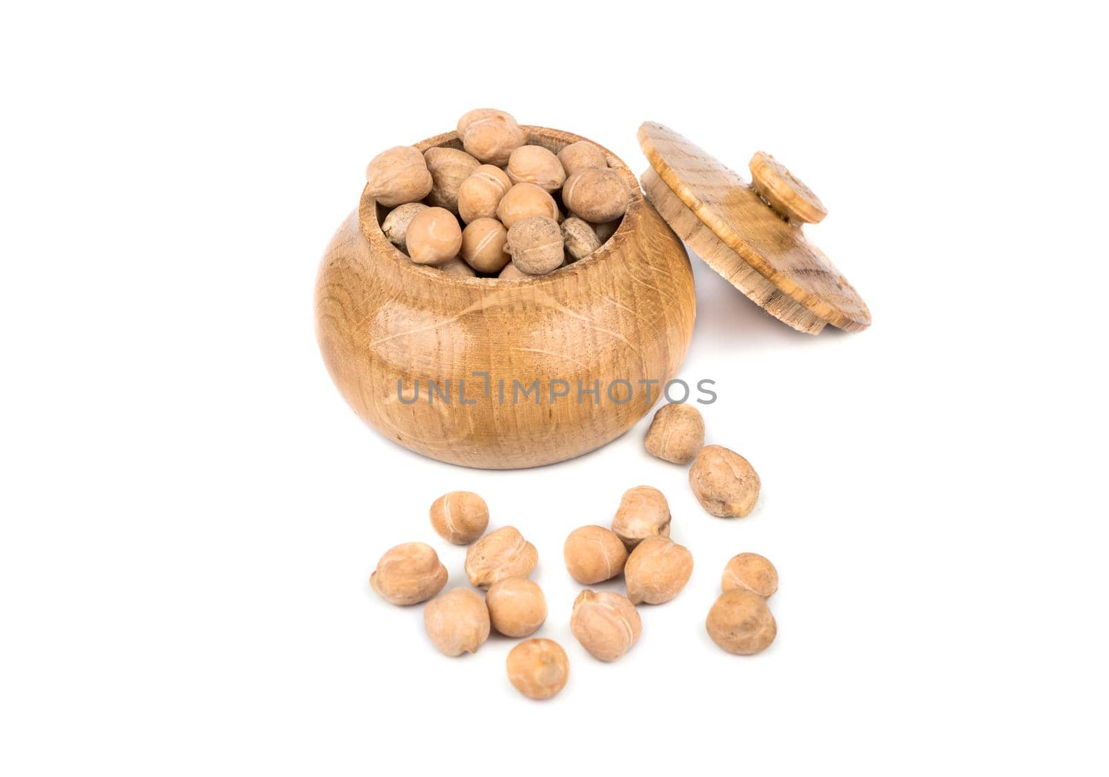 Dry chickpeas in a wooden capacitance on a white background