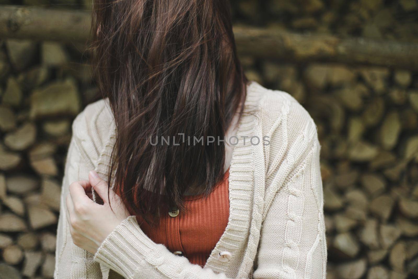 Young brunette woman with beautiful hair flying in the wind outdoors by paralisart