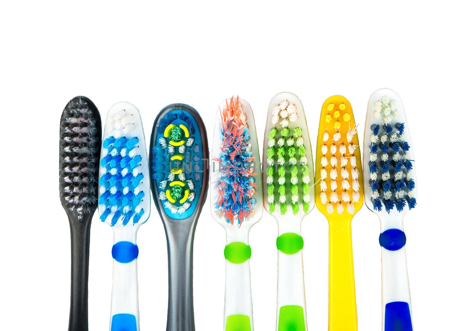 Several multi-colored toothbrushes on a white background