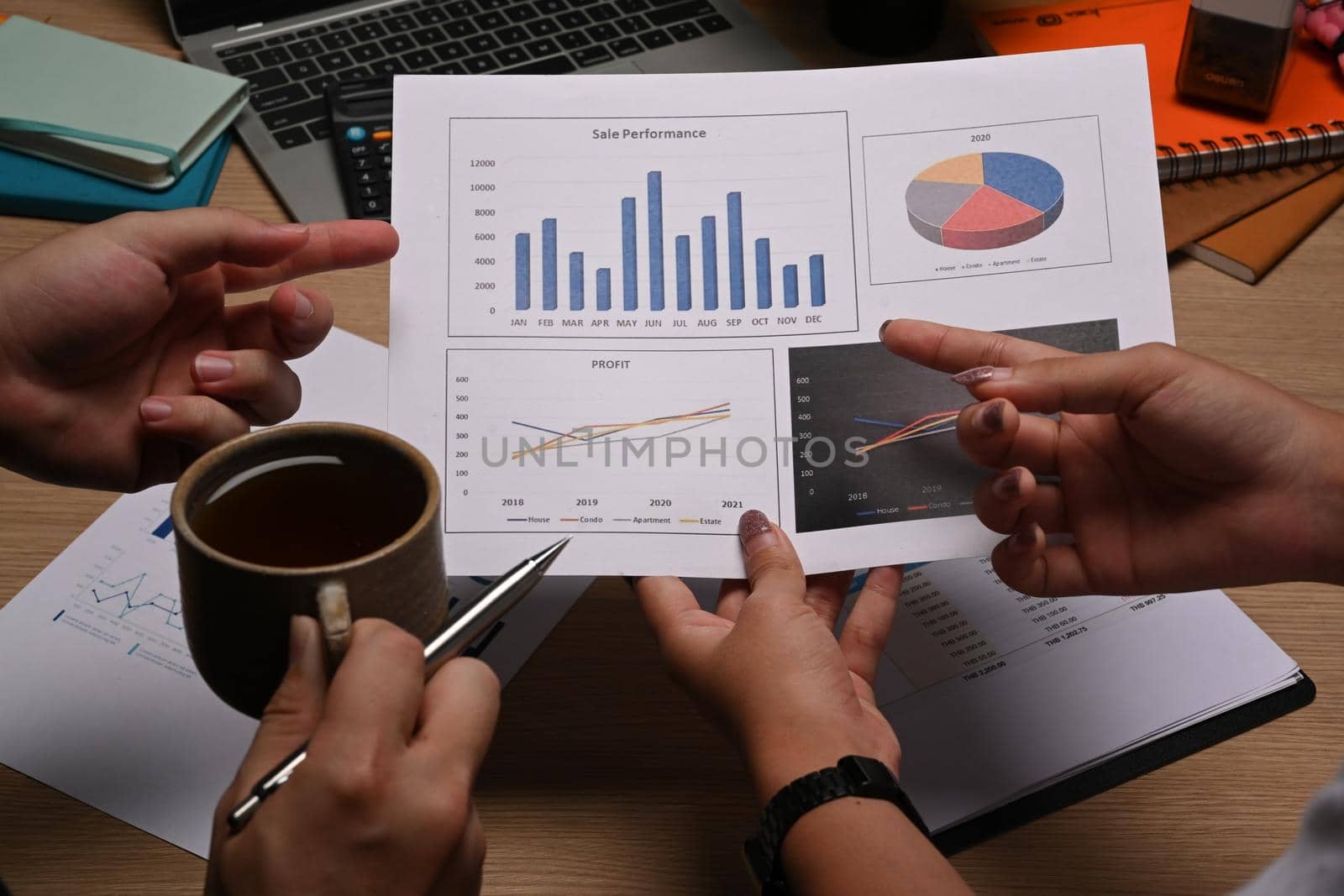 Close up image of businesspeople analyzing financial graph together.