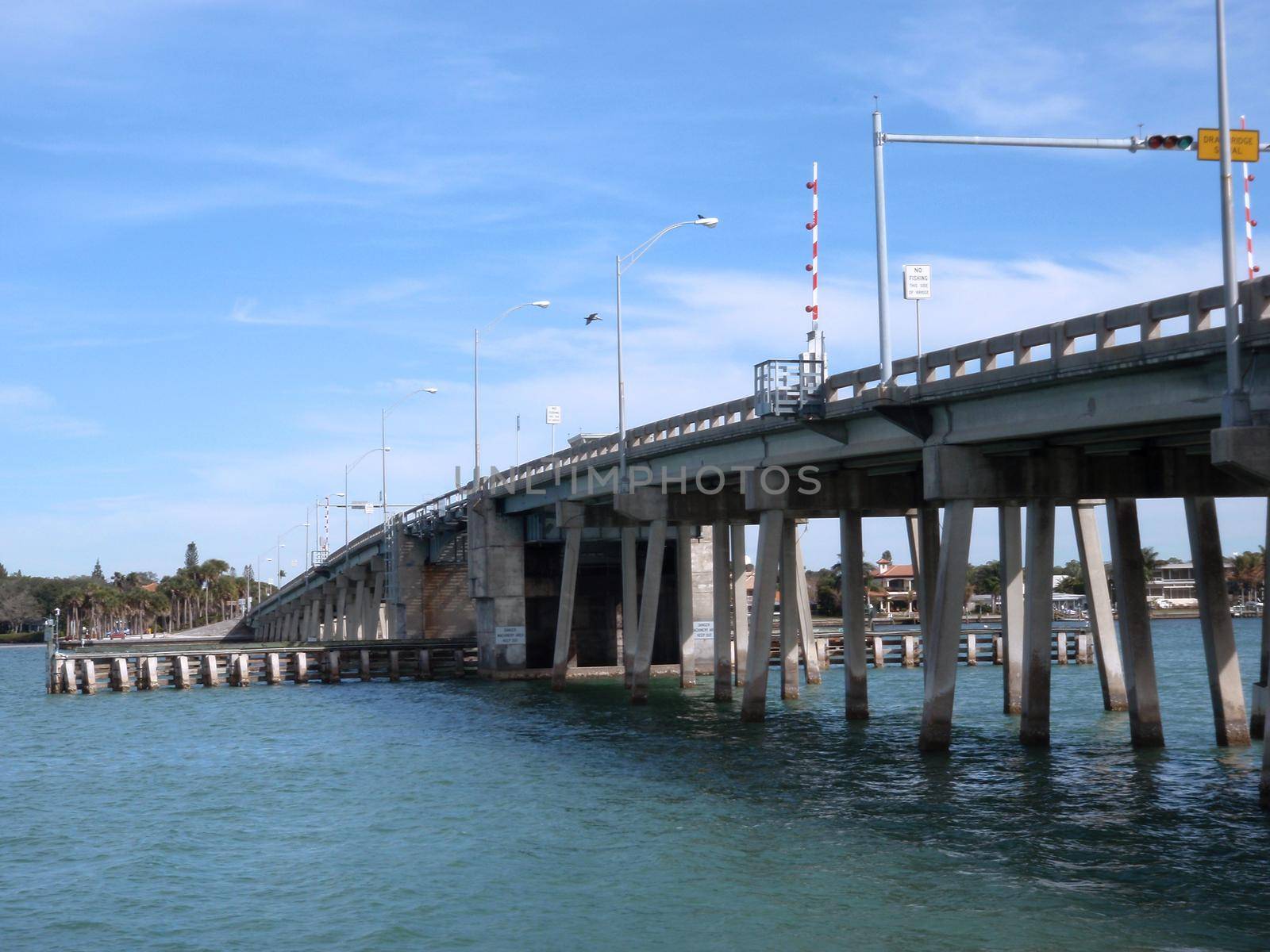 Siesta Keys North Bridge with bird flying over by EricGBVD