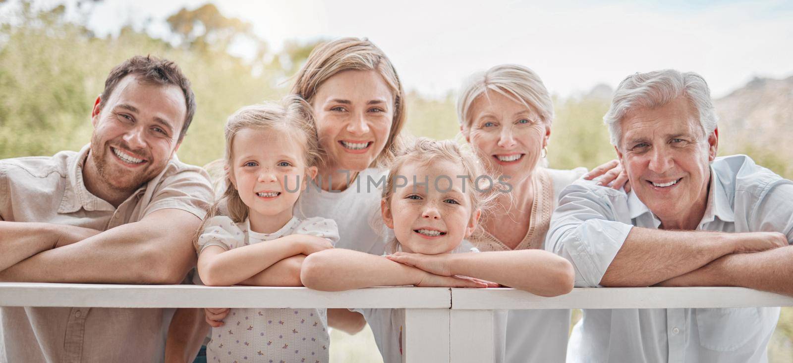 Portrait happy smiling caucasian family standing together in the garden at home. Little girls bonding with their mother, father, grandfather and grandmother in a backyard by YuriArcurs