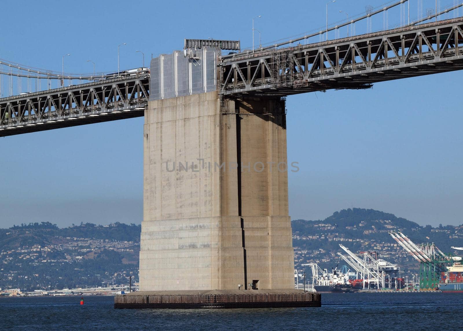 Moran's Island - San Francisco Bay Bridge Center anchorage between the shoreline and Yerba Buena Island with Oakland Harbor in the background.  The anchorage is a monolithic concrete pier supporting one end of each of the two suspension bridges connecting Yerba Buena Island with San Francisco.   The Largest concret structure in the world at time of building.