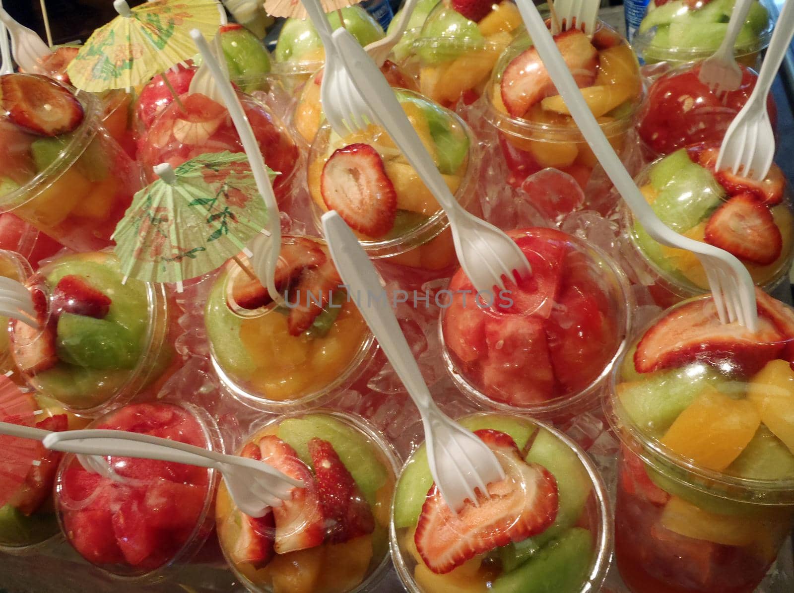 Plastic Fruit cups with forks placed in the top on display by EricGBVD