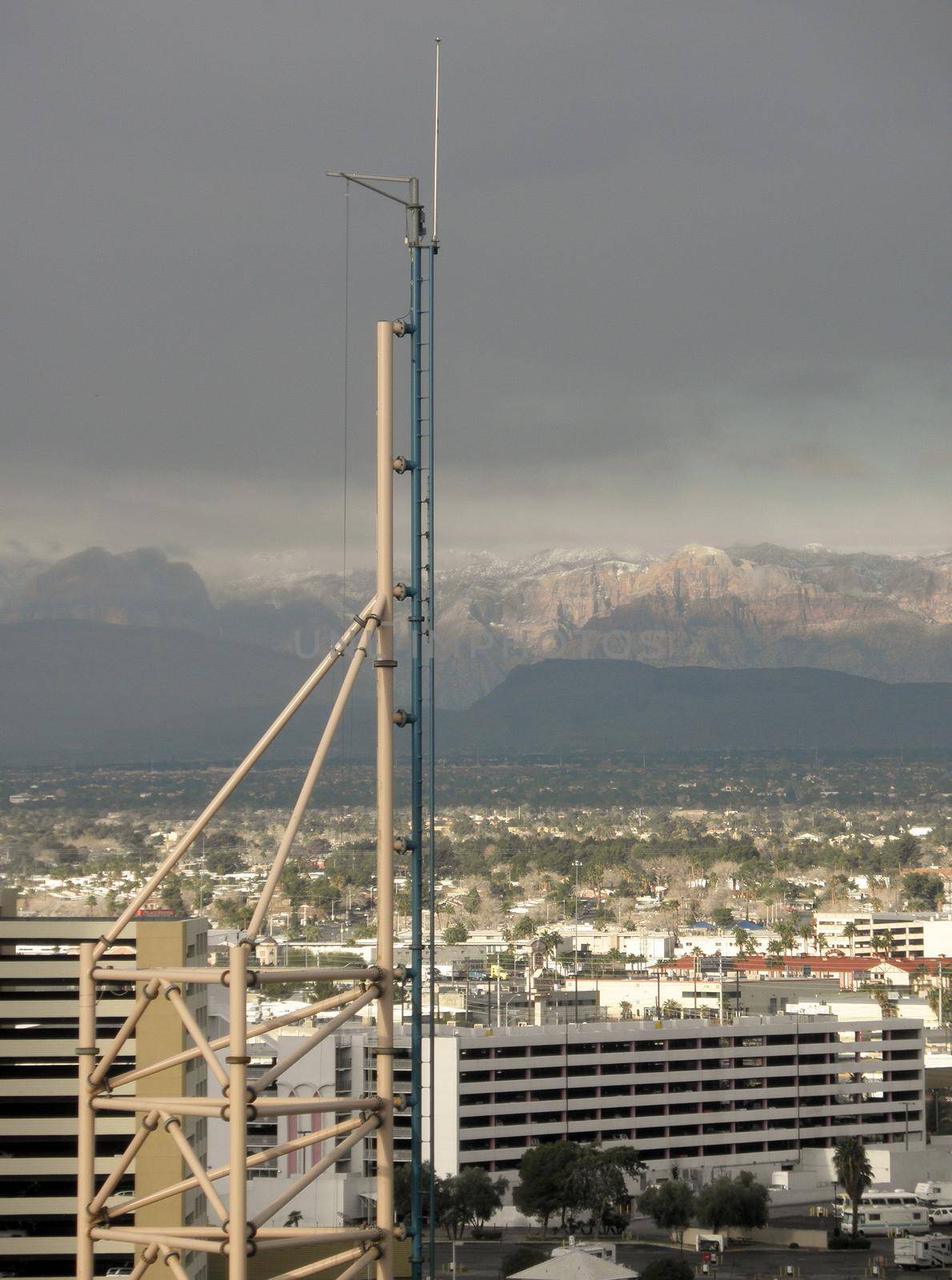 End of Rollorcoaster tracks in Las Vegas.  City desert and Snowcapped mountians visible in the background.