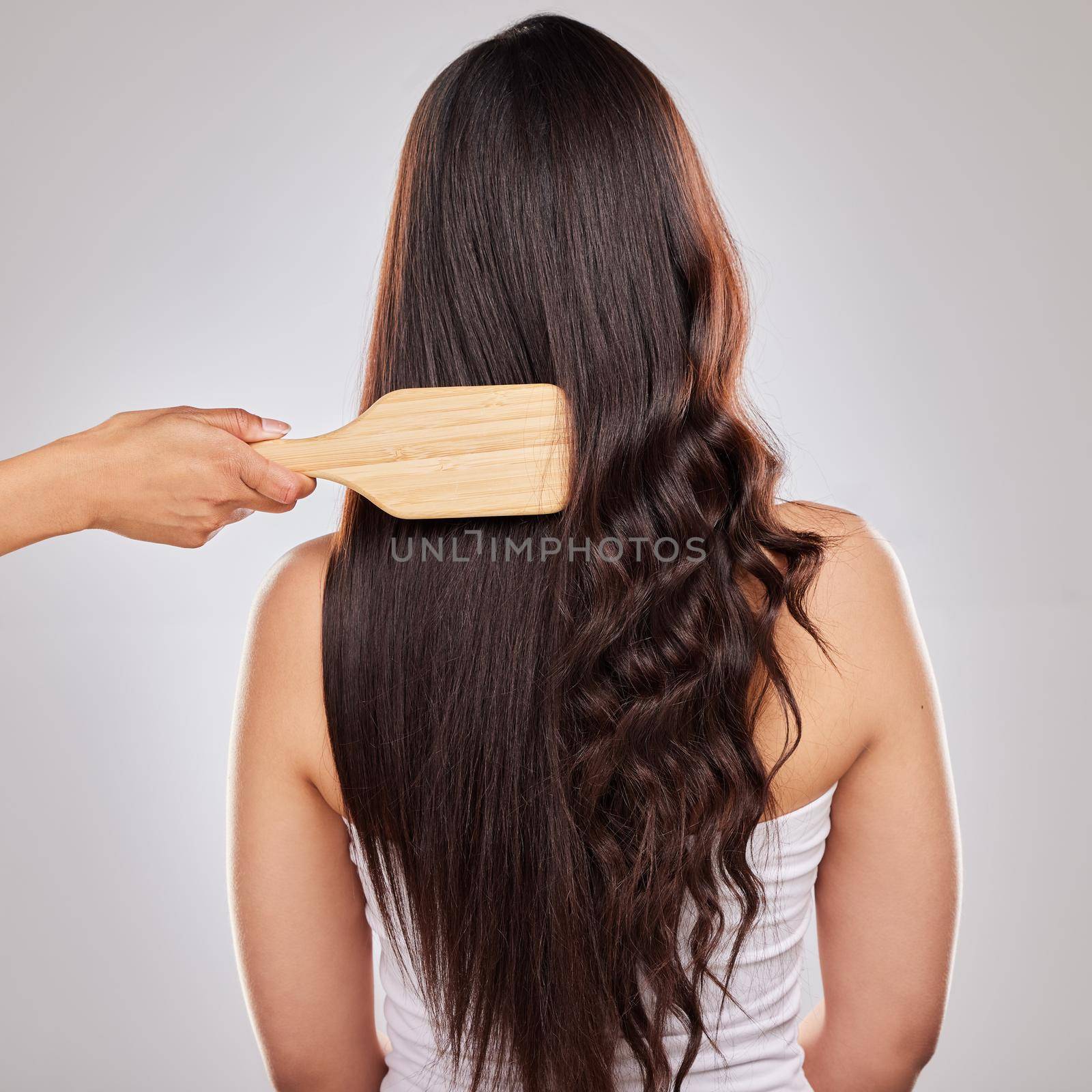 How you take care of your hair determines the results you get. Shot of a woman posing with half straightened and half curled hair. by YuriArcurs