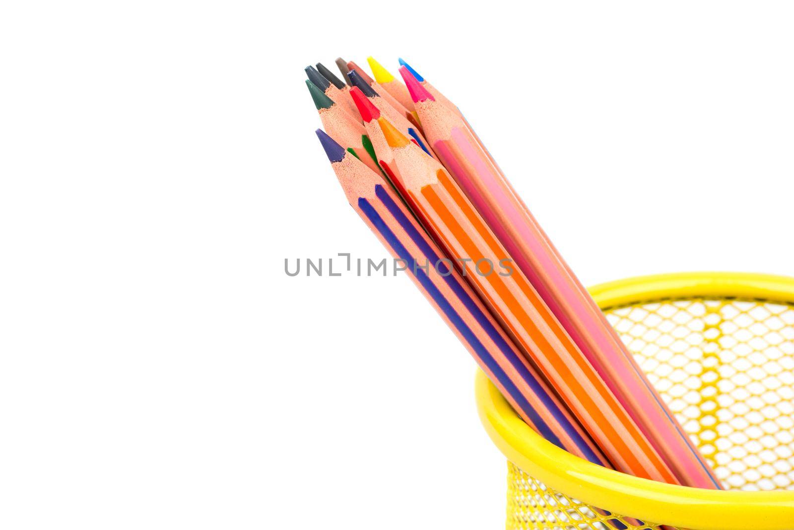 Colored pencils in a metal basket on white background