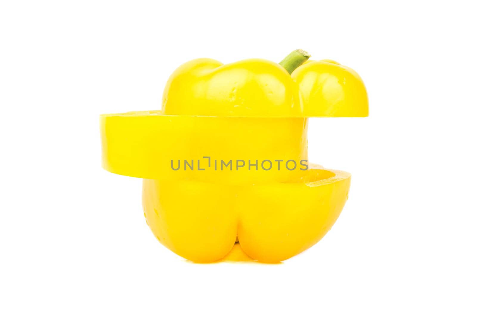 Fresh yellow pepper cut into three pieces on white background