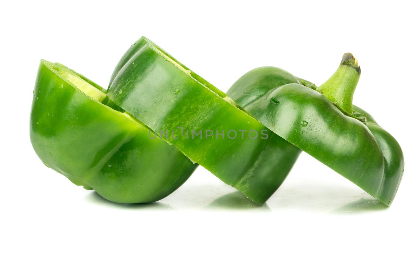 Fresh cut green pepper into three pieces on white background