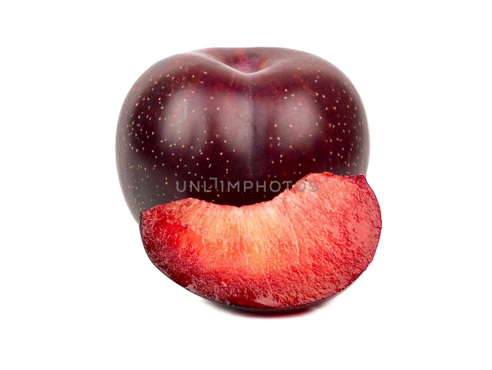 Fresh red plum with juicy slice, isolated on white background