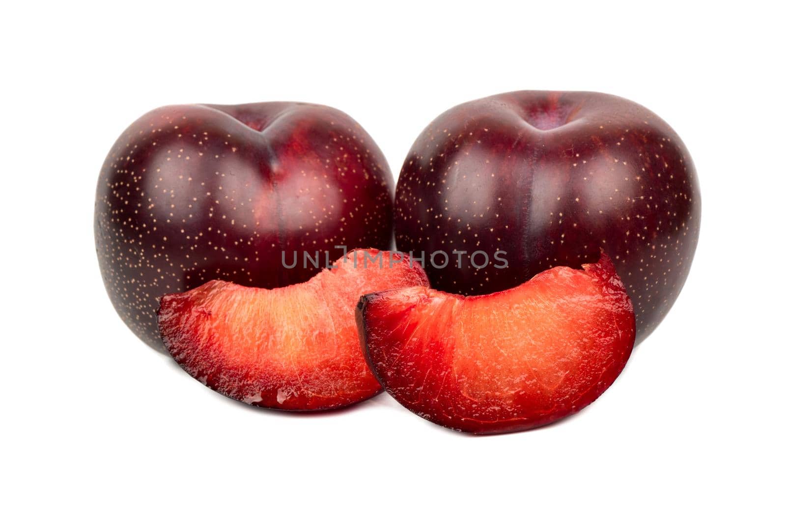 Tasty red plum with two slices on a white background