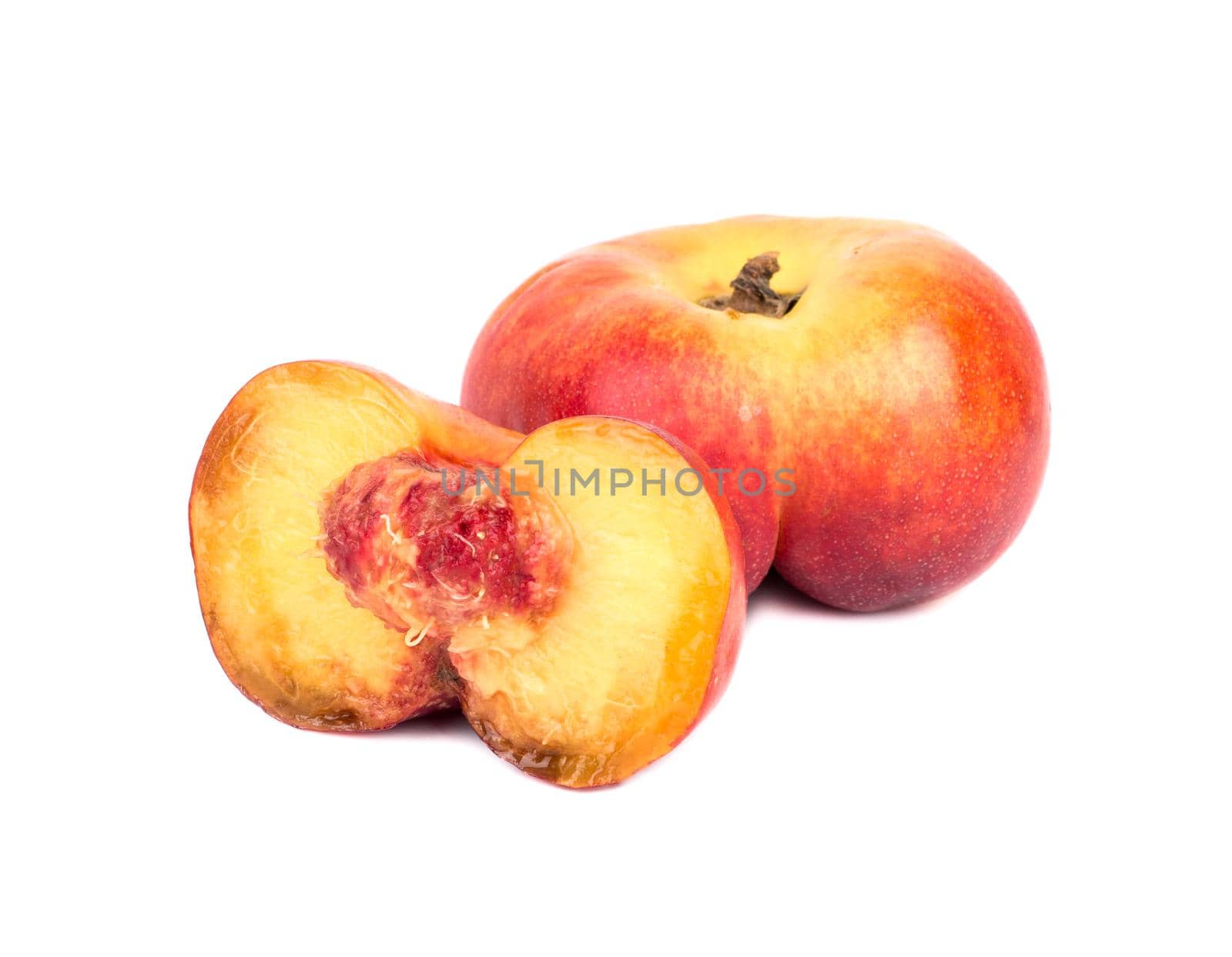 Flat peach with juicy halves on a white background
