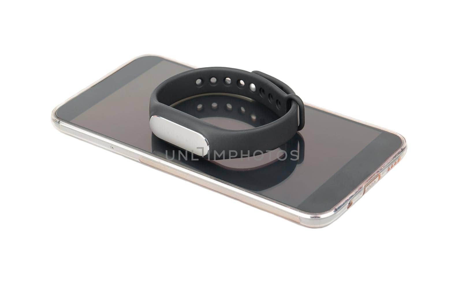 Smartphone and fitness pedometer bracelet on a white background