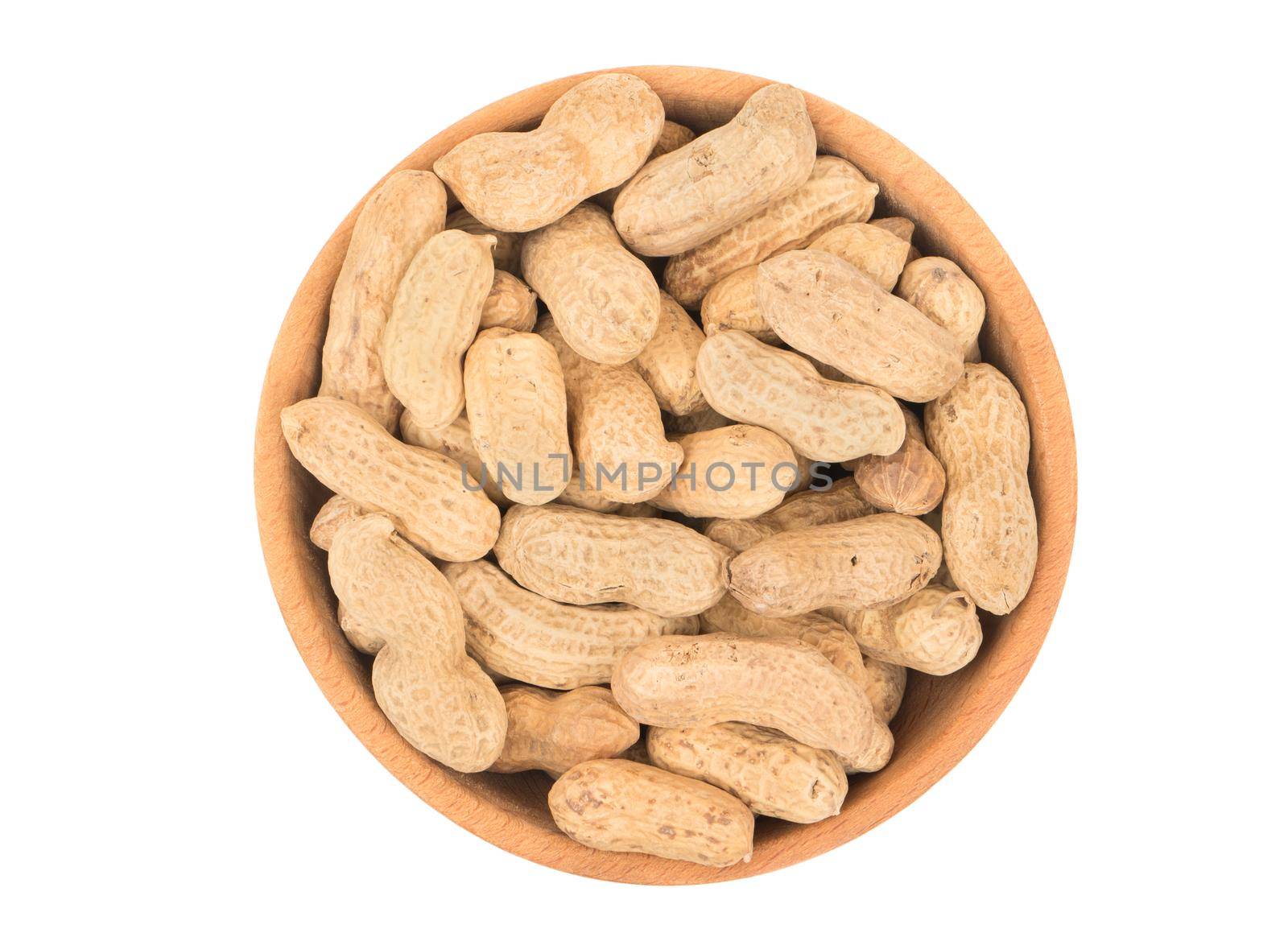 Peanuts in the shell and a wooden bowl isolated on white background, top view