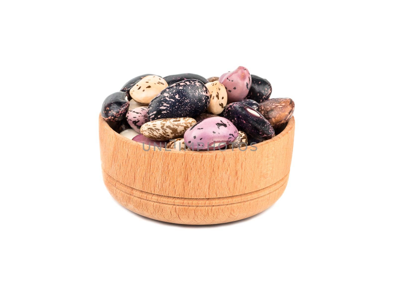 Wooden bowl filled with colored beans isolated on white background