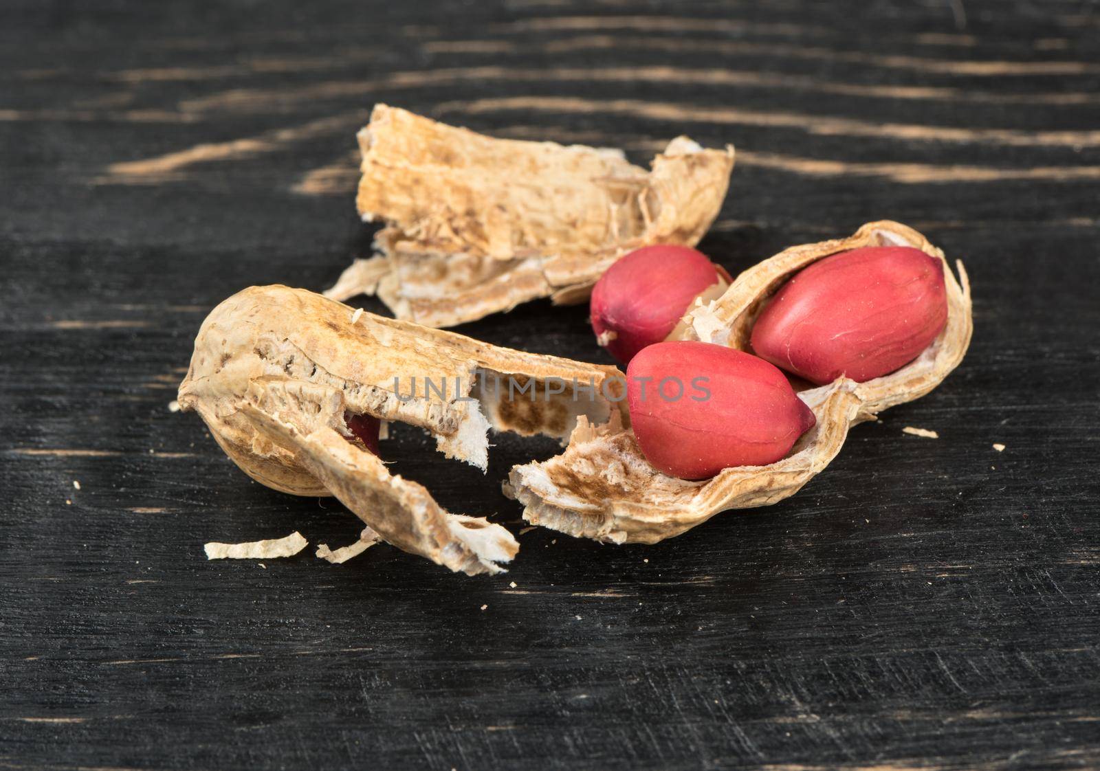 Broken peanut in shell on a wooden background close-up