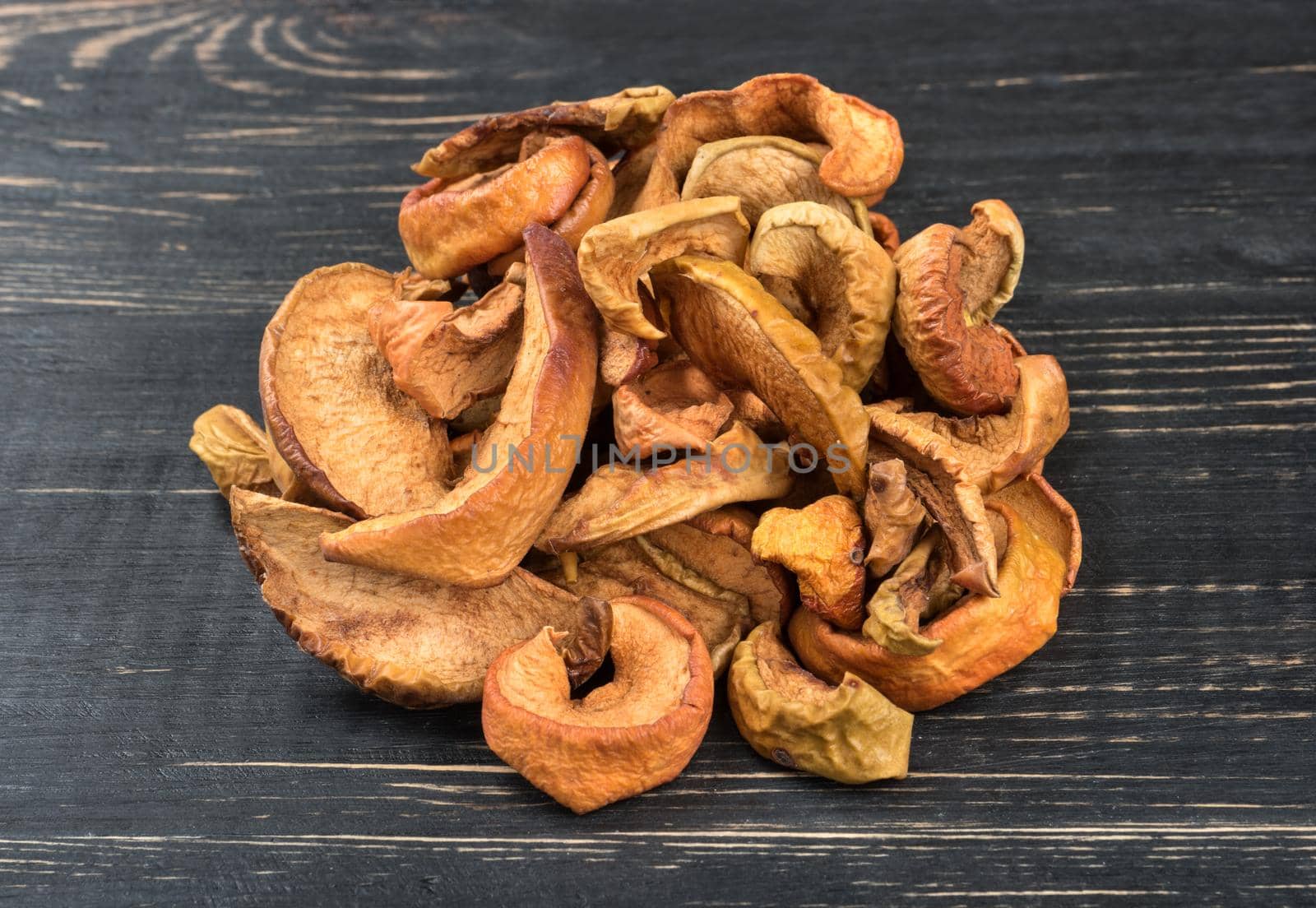 Bunch of dried Apple slices on a dark table