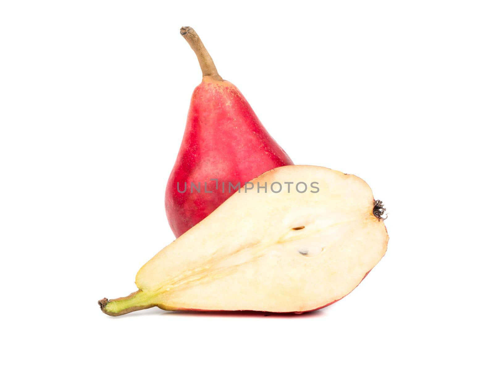 Ripe red pear with a juicy half on white background