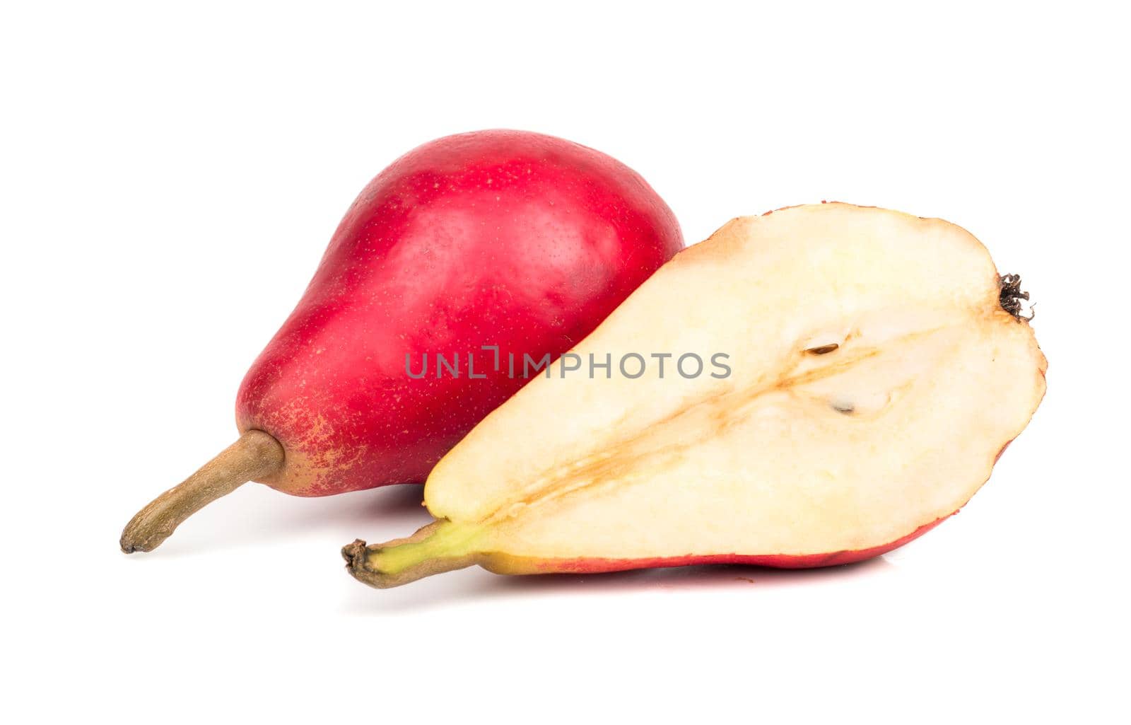 Ripe red pear with a juicy half on white background