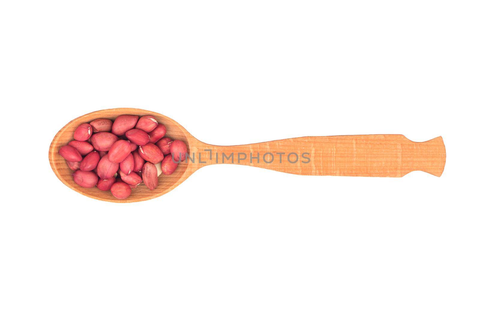 Kernel peanut in wooden spoon isolated on white background, top view