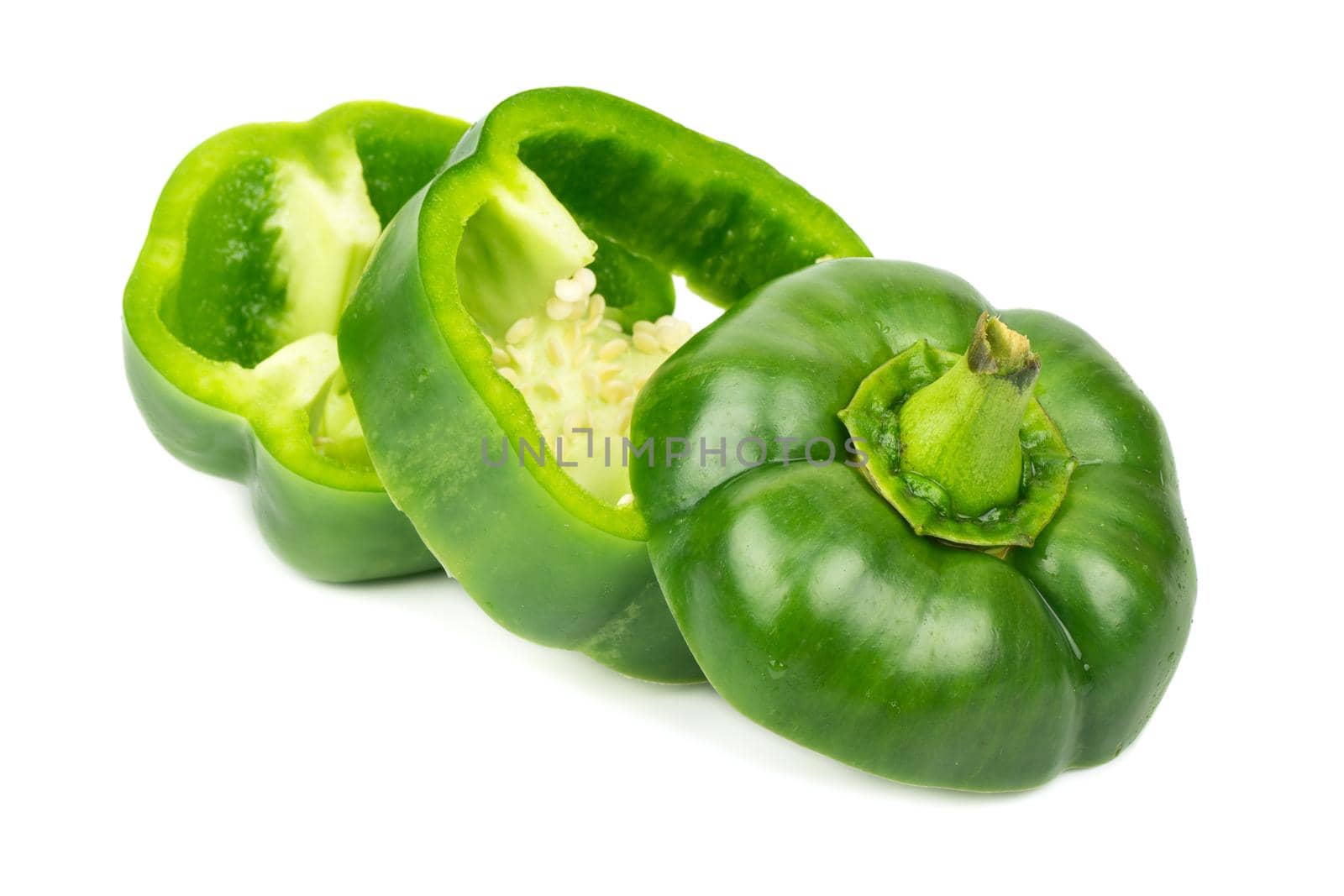 Fresh cut green pepper into three pieces on white background
